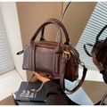 Detail view of a vintage dark brown Boston bag with matte PU leather and gold hardware - Coffee