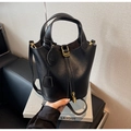 Close-up of black leather bucket bag featuring gold padlock and smiley face charm - Black