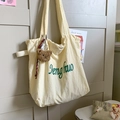 Minimalist creamy white tote bag with green text, plush bear charm and plaid ribbon detail - Yellow with Pendant