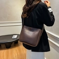 Minimalist dark brown shoulder bucket bag with matte finish and fashion logo - With Charm / Brown