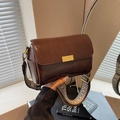 Retro dark brown leather pillow bag with wide geometric woven shoulder strap and gold hardware - Brown