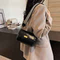 Retro black leather pillow bag featuring a stylish wide black and white woven strap - Black