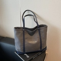 Canvas tote bag with dark grey body and navy blue denim trim, featuring front pocket - Dark Brown