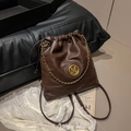 Dark brown leather bucket backpack with gold M logo and chain detail for women - No Pendant / Brown