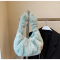 Detailed view of light green faux fur cloud bag featuring fluffy pleats and gold chain - Green