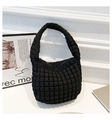 Detail shot of the black quilted texture and puffy fabric on the pleated bucket bag - Black