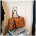 Detailed macro view of brown vintage faux leather tote with dual zippers and decorative charm - Brown with Pendant