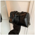 Close-up of black oil-wax leather tote bag showing smooth texture and metal hardware - Black with Pendant