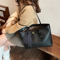 Black pebbled leather tote bag with gold logo and polka dot silk scarf decoration - Black