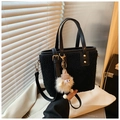 Detail of black faux fur tote bag with leather straps and cute plush ball charm - Black (With Charm)