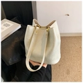 Close-up of cream bucket bag with MOCOMU logo and premium gold hardware detail - White
