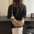 Brown leather crescent shoulder bag with baseball charm displayed on model back - Gray with Charm