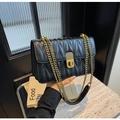 Detail of black quilted leather shoulder bag with gold chain and vintage metal twist lock - Black