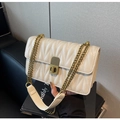 Close-up of white quilted leather texture with vintage bronze chain and twist lock - Off White