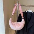 Light pink plush crescent bag with adjustable strap shown against a neutral wall - No Pendant / Pink