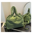 Detail of green puffy tote bag with drawstring closure and padded handles - Green