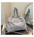 Detail view of large grey quilted nylon tote bag with soft padded texture and drawstring - Gray