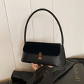 Chic black underarm bag with lychee leather and suede texture featuring a vintage gold buckle - Black