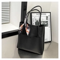 Close-up of black litchi grain leather bucket bag with a stylish geometric print silk scarf - Black