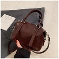Detail of dark reddish-brown Boston bag showing pebbled texture and silver hardware - Wine Red Without Pendant