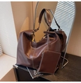 Detail of dark brown tote bag with contrast stitching and matching small zipper pouch - Brown