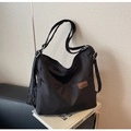Black canvas crossbody bag with fashion logo patch and adjustable wide strap - Black