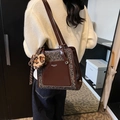 Deep brown leopard print tote bag with plush charm and glossy leather finish - Leopard Coffee With Tassel