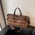 Large plaid travel duffle bag with brown leather handles and adjustable shoulder strap - Brown