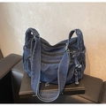 Gros plan du sac en jean bleu foncé avec fermetures éclair et détails à franges - Bleu foncé