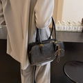 Classic black rectangular leather shoulder bag with gold hardware and striped bow charm - Black