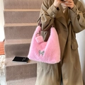 Sac à main en fausse fourrure rose avec papillon métallique et pompon porté à l'épaule - Rose foncé