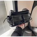 Detail of black PU leather baguette bag with dual flap pockets and drawstring straps - Black