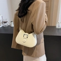 Chic beige leather underarm dumpling bag with silver buckle worn with camel blazer - Off White