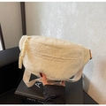 Detail of soft cream white sherpa fleece chest bag with orange label and sturdy zipper - Off White