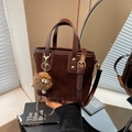 Deep brown vintage suede bucket bag with leather trim and cute monster keychain accessory - Coffee