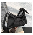 Detail shot of the black quilted cloud bag showing nylon texture and knotted strap design - Black