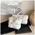 Modern white quilted tote bags in two sizes displayed against a minimalist artistic backdrop - White Large