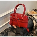 Detalle del bolso rojo brillante tipo concha con herrajes plateados y bandolera - Rojo