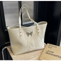 Chic cream tote bag with pleated texture and silver butterfly buckle detail - Off White