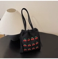 Detail of cherry embroidery on black canvas drawstring bucket bag with tassels - Black