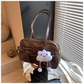 Detail of dark brown PU leather shoulder bag with decorative bow and plush cloud charm - With Charm / Brown