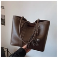 Detailed shot of dark brown tote bag featuring white contrast stitching and cat charm - With Charm / Brown