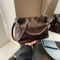 Dark brown pleated leather bucket bag with a spiral handle and silver metal chain - Brown