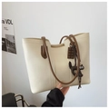 Detail of a minimalist beige tote bag with brown straps and cute cat charms - With Charm / Off White