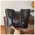 Detail of black leather tote bag with white contrast stitching and cat charm pendant - With Charm / Black