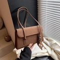 Vintage brown faux suede shoulder bag with flap closure and decorative pendant detail - Brown