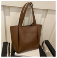 Detail of dark brown tote bag with lychee texture faux leather and front pocket design - Brown
