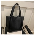 Close-up of black PU leather tote bag with lychee texture and front slip pocket detail - Black