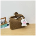 Brown teddy fleece shoulder bag with a cute puppy heart pendant on a wooden table - Brown