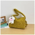 Close-up of curly plush mustard yellow shoulder bag with a cute white dog charm - Yellow